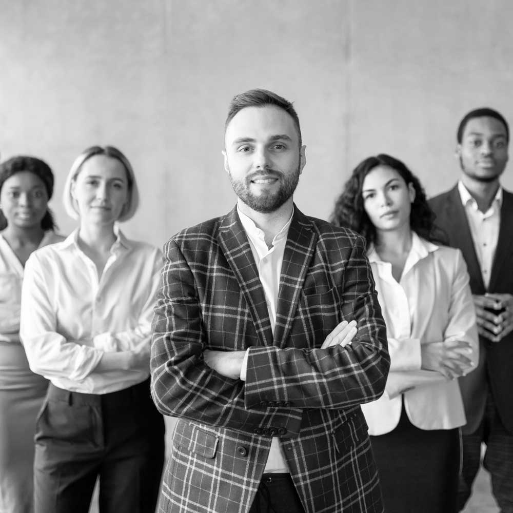 businessman-standing-in-front-of-his-business-team